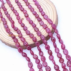 a close up of a necklace with pink beads