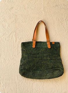 These gorgeous handwoven totes are designed and produced in Cape Town, South Africa.  Each piece is composed from sun dried raffia and leather. Please note some will be a deep moss green while others may appear more emerald- as they are all hand dyed variations may occur Eco-friendly Crochet Jute Bag With Woven Leather, Eco-friendly Crochet Bag With Woven Leather Details, Eco-friendly Crochet Bag With Woven Leather, Eco-friendly Jute Crochet Bag With Woven Leather, Green Jute Bags With Braided Handles, Handwoven Green Crochet Beach Bag, Green Woven Jute Bag, Green Handwoven Beach Shoulder Bag, Green Handwoven Shoulder Bag For The Beach