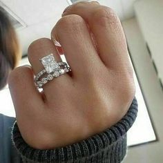 a woman's hand with a diamond ring on it