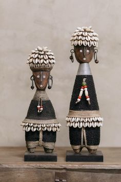 two african figurines made out of wood and beaded with beads on them