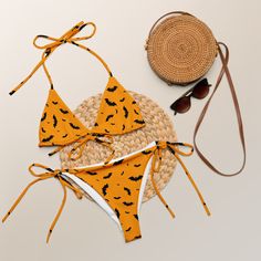 Stay comfortable and stylish all summer with this All-Over Print Recycled String Bikini set. It’s made from soft recycled polyester with double-layering and UPF 50+. Style the straps how you like, and get ready to swim! • Soft and stretchy material with UPF 50+ • Sizes up to 6XL • Bikini top comes with removable padding for comfort • Multiple ways to tie and style the bikini set • Color design options for swimwear lining Disclaimers: • Due to the 2-layered construction and internal stitching, a visible stitch may appear in the crotch seam of the bikini bottom. This is a normal part of the manufacturing process and does not impact the quality or performance of the product. • To make your All-Over Print Recycled String Bikini last longer, thoroughly rinse it off after each use and get rid of Yellow Swimwear With Adjustable Straps For Beach Party, Vacation Nylon Swimwear With Tie-side Bottom, Orange Nylon Swimwear For Vacation, Nylon Triangle Top Swimwear For Vacation, Nylon Swimwear For Beach Vacation, Nylon Swimwear For Vacation, Seamless Swimwear For Summer Vacation, Vacation Swimwear With Adjustable Straps And Stretch, Orange Tie-side Bottom Swimwear For Summer