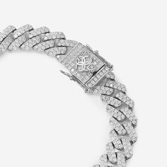 Elevate your style with the Golden Concept Cuban Link Bracelet, a masterpiece of luxury and craftsmanship. Crafted from premium sterling silver and adorned with natural Zircon gems, this bracelet radiates brilliance and sophistication. Weighing 42 grams and polished to perfection, it embodies elegance with a 12 mm thickness. Available in sizes S (17.5 cm), M (19 cm), and L (20.5 cm), it ensures a perfect fit, blending comfort with luxury. The meticulous attention to detail and flawless finishing Silver Diamond Chain Bracelet With Pave Setting, Formal Silver Chain Bracelet With Pave Setting, Luxury Silver Chain Bracelet With Pave Setting, Silver Chain Bracelet With Pave Setting, Diamond Cuban Link Jubilee Bracelet In White Gold, Elegant White Gold Cuban Link Diamond Bracelet, Luxury Sterling Silver Chain Bracelet With Diamond Accents, Elegant White Gold Cuban Link Bracelet With Diamond Accents, Luxury Cuban Link Bracelet In Diamond White