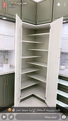 an empty pantry in a kitchen with green cabinets and marble counter tops on the floor