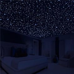 a bedroom with stars on the ceiling and white furniture in it's dark room