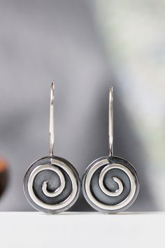 "These earrings are part of my spiral series. They are handcrafted of sterling silver with sturdy 19 gauge ear wires that clip securely in the back. They measure 5/8\" in diameter and about 1 1/8\" in length, and have a bright, shiny finish. I will ship these earrings via USPS First Class Mail within 3-5 days of receipt of payment." Spiral Earrings With Ear Wire As Gift, Spiral Earrings With Ear Wire For Gifts, Unique Spiral Earrings For Gift, Nickel Free Silver Swirl Earrings, Handmade Spiral Earrings As Gift, Spiral Single Earring Gift, Spiral Single Earring As Gift, Nickel Free Spiral Earrings For Everyday, Spiral Single Earring For Everyday Wear