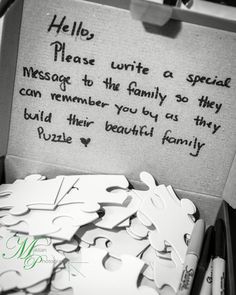 a box filled with lots of pieces of paper next to a marker board that says hello please write a special message to the family so they can remember you by as they build their