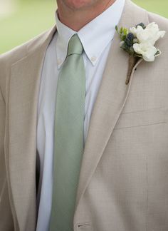 a man in a suit with a flower on his lapel