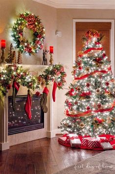 a decorated christmas tree sitting in front of a fireplace