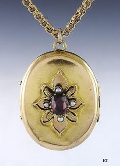 Presented is a fabulous 14 karat gold Victorian American locket pendant with chain. This piece dates to around the 1870s. The locket is oval form with a stylized flower on the front. The center of the 'flower' is an oval faceted garnet, which is a rich red-pink stone. Surrounding the garnet are four real seed pearls. The interior of the locket has the original bezel and glass on each side, perfect for a photo, a lock of hair, or other memento. There is enough space behind the glass for folded pa Victorian Oval Jewelry For Opera, Ornate Oval Antique Gold Jewelry, Ornate Oval Jewelry In Antique Gold, Victorian Gold Jewelry For Opera, Victorian Oval Locket Necklace With Intricate Design, Antique Oval Pendant Locket Necklace For Wedding, Antique Oval Locket Necklace For Wedding, Antique Medallion Jewelry With Historical Design, Vintage Gold Jewelry For Opera