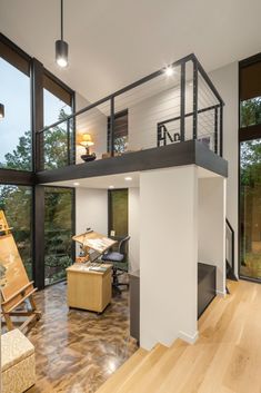 an open floor plan with stairs leading up to the upper level, and lots of windows