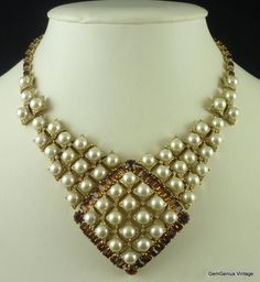 Pearl and Rhinestone Designer Bib   This is a substantial articulated bib necklace set with cabochon pearls and baguette rhinestones sprinkled throughout the design with tiny clear rhinestone chatons.  Although not signed the weight, quality of design and attention to detail suggests that this is a designer piece.  The condition is very good indeed with minimal signs of wear. Maximum wearable length is approximately 15 ½".  The central lozenge  measures 2 ½"  long by 2 ½" wide. Bib Necklaces, Bib Necklace, Clear Rhinestones, Necklace Set, Jewelry Necklaces, Etsy Uk, Gold, Design, Baguette