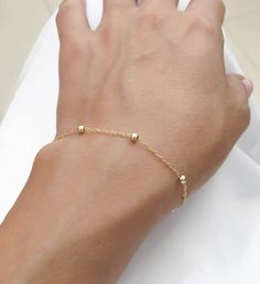 "Simple. Chic. Minimalist™ A perfectly dainty, lightweight, most feminine gold filled bracelet. This bracelet is made with 14k gold filled dots measure 3mm each and 14K gold filled chain, personalized with a tiny 14K gold plated initial and wire wrapped pearl for an extra classy look. Also can be wear as an anklet- simply choose large size at checkout. 〰 All parts are made with top quality materials! Also available with sterling silver or 14K Rose gold filled Model is wearing 6.5\" length This b Personalized Gold Bracelet, Wire Wrapped Pearl, Initial Bracelet Gold, Bracelet Minimalist, Personalized Bracelet, Simple Chic, Minimalist Bracelet, Initial Bracelet, Gold Initial