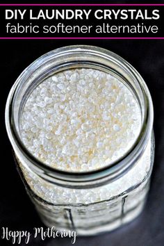 a glass jar filled with white glitter next to the words diy laundry crystals fabric softener alternative