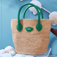 Inspired by a recent trip to Italy, the Mia Handbag is a beautiful bag for summer days, wedding celebrations or any time you need a touch of luxury. Its beauty is in its simplicity: handwoven raffia meets soft and supple Italian leather. This unlined open tote instantly evokes long summer days on the Italian countryside. Add a foil debossed monogram for a personal touch.    7.5"w (bottom), 13.5"w (top) x 4.75"d x 10"h  Handle drop: 4"  Handwoven raffia, Italian leather.  Clean with a soft cloth.  Made in Italy.  Monogramming is foil debossed. Luxury Bag With Rolled Handles In Natural Color, Luxury Natural Shoulder Bag With Rolled Handles, Elegant Natural Woven Leather Bag, Elegant Woven Leather Beach Bag, Elegant Beach Bag With Leather Handles For Vacation, Elegant Handwoven Beach Bag With Double Handle, Elegant Handwoven Double Handle Beach Bag, Elegant Crochet Bag With Leather Handles In Natural Color, Elegant Natural Crochet Bag With Leather Handles