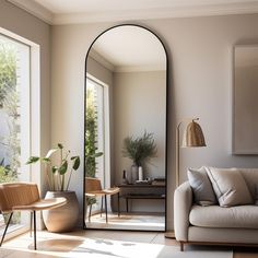 a living room filled with furniture and a large mirror in the middle of it's wall