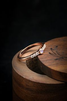 Product Details Ring Style: A dainty-stylemoonstone women's stacking bandwith delicate and ornate details and is available with many center stone options Center Stone:2.5mm Round Moonstone Materials: 14K rose gold stacking band featuring a moonstonecenter stone and a 1/6 ctw diamond accents Customizable:Because each of our rings are handcrafted to order, wecan customize yours using unique materials, gemstones, or design features. Contact us to make your ring even more meaningful! Swap Your Stone Elegant Stackable Moonstone Ring With Diamond, Elegant Adjustable Moonstone Stackable Rings, Stackable Moonstone Diamond Ring As Gift, Adjustable Rose Gold Moonstone Jewelry, Elegant Rose Gold Moonstone Jewelry, Elegant Stackable Moonstone Jewelry, Round Moonstone Jewelry With Diamond Accents, Moonstone Jewelry With Diamond Accents In Round Shape, Rose Gold Moonstone Ring With Rose Cut Diamonds