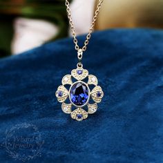 "Jewelry Details -Gold Type: Solid 10K Gold / Solid 14K Gold (Choose One in Material Option) -Center Stone: Lab Created Sapphire 7*9mm, Approximately 2.55ct Color: Blue--- 5A Clarity: VVS Cut: Oval Cut / 3EX -Side Stone: 0.16cttw moissanite Color: DEF Clarity: VVS1 Cut: Round Cut / 3EX -Pendant Width: 18.5mm -Pendant Height: 27mm The chain are not included, please contact me if you need chains. SKU: YP0044 ~*-*~Purchase Guarantee: - All our jewelry is handmade, and each process is refined. - 14 Elegant Blue Flower Pendant Jewelry, Elegant Blue Hallmarked Necklace, Blue Gemstone Flower Pendant Jewelry, Exquisite Tanzanite Jewelry With Sapphire Color, Exquisite Sapphire Tanzanite Jewelry, Exquisite Sapphire Necklace For Anniversary, Exquisite Sapphire Necklaces, Exquisite Sapphire Necklace, Luxury Tanzanite Necklace For Anniversary