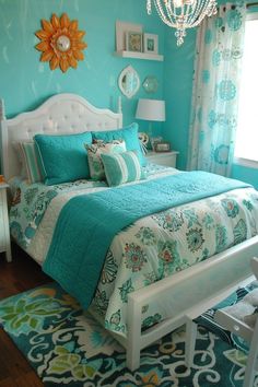 a bed room with a neatly made bed and a chandelier