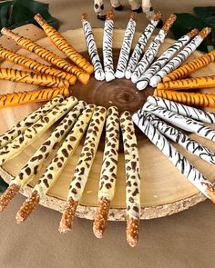 there are many different types of sticks in the center of this cake plate with zebra print designs on them