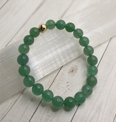 *GREEN AVENTURINE FOR ABUNDANCE AND CAREER SUCCESS* Green Aventurine is one of the luckiest stones. It helps to manifest prosperity, abundance and success. It aids in healing emotions from childhood trauma. **FOR HEART CHAKRA MEDITATION** INCLUDES: 1 Green Aventurine beaded stretch bracelet with 14K gold filled spacer (8mm Beads) 1 Description/Affirmation Card *ALL BRACELETS ARE HANDMADE WITH LOVE LIGHT AND POSITIVE INTENTION* Healing Emotions, Heart Chakra Meditation, Green Aventurine Crystal, Aventurine Crystal, 8mm Beads, Lucky Stone, Love Light, Chakra Meditation, Career Success