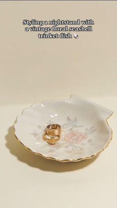 two gold wedding rings sitting in a flowered porcelain dish with the words, i'm getting married