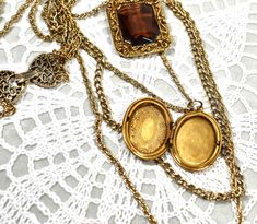 "This is truely a rare find, a 1950 circa neckalce is made by Goldette a company well know for lockets, pendants and intrigent design work. Four varing sized gold tone chains holds a large Goldette pendant with open back Golden faceted crystal set in a gold tone richly ornate rectangle and the locket is ornately etched, antiqued gold tone in \"mint\" condition inside and outside. Stamped GOLDETTE on clasp. Please feel free to compare this necklace with other Goldette's. You will find it to be pr Gold Costume Jewelry Necklace For Vintage Events, Vintage Gold-tone Locket Necklaces, Vintage Antique Gold Chain Necklace, Vintage Gold Necklace For Vintage Events, Gold Medallion Jewelry For Vintage Events, Gold Locket Jewelry For Vintage Events, Gold Vintage Necklace For Vintage Events, Vintage Costume Jewelry Locket, Gold Locket For Vintage Events