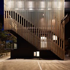 the building has wooden slats on it's sides and is lit up at night