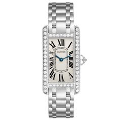 Cartier Tank Americaine White Gold Diamond Ladies Watch WB7073L1. Quartz movement. 18K white gold case 19.0 x 35.0 mm. Octagonal crown set with original Cartier factory faceted diamond. . Scratch resistant sapphire crystal. Silvered grained dial with black Roman numeral hour markers and an inner minute track. Sword-shaped blued steel hands. 18K white gold bracelet with hidden butterfly clasp. Fits a 6" wrist. Cartier Tank Americaine, Cartier Ballon Bleu, Cartier Tank, Cartier Watch, White Gold Bracelet, Gold Case, Bezel Diamond, Ladies Watch, Roman Numerals