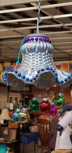 an assortment of christmas ornaments hanging from a ceiling