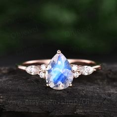 "This is a 1.3 carat natural moonstone engagement ring in solid gold,about 6X8mm pear cut. The accent stones are round 1.5mm and marquise 2x4mm moissanites. It can be made in any ring size. However please contact me to custom make it to a special big or small size. It can be made in white gold,rose gold or yellow gold with 14k or 18k. However for some people who are nickel allergic,I can also make it to 925 sterling silver to make you can wear it. The ring is handmade,very high quality! 30 days Luxury Solitaire Moonstone Ring For Anniversary, Elegant Teardrop Moonstone Ring, Teardrop Moonstone Jewelry With Rose Cut Diamonds, Solitaire Pear-shaped Promise Ring Jewelry, Pear-shaped Solitaire Jewelry For Promise, Rose Cut Pear-shaped Diamond Promise Ring, Pear-shaped Solitaire Promise Jewelry, Pear-shaped Rose Cut Diamond Promise Jewelry, Elegant Pear-shaped Moonstone Ring