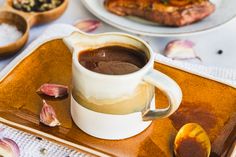 a cup of hot chocolate sits on a plate