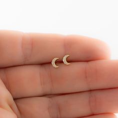 Such a cute, and dainty pair of earrings! They're perfect alone or stacked. They're a tiny pair that are perfect for second piercings, cartilage piercings, or for a minimalist touch. ✤✤ Details ✤✤ ★ Made of 925 Sterling Silver ☾ We use a THICK plating of 14k Gold or Rhodium for a piece that is sure to last you years to come ★ Sold as a PAIR ☾ Nickel-free & Hypoallergenic ★ Measures 5 mm x 4 mm ☾ We use the highest grade of cubic zirconia for an authentic diamond look Comes in a cute gift box Second Stud Earrings Indian, Dainty Half Moon Charm Earrings, Dainty Half Moon Earrings With Moon Charm, Dainty Moon Phase Earrings, Dainty Crescent Cartilage Earrings As Gift, Dainty Moon Shaped Hypoallergenic Earrings, Dainty Moon-shaped Hypoallergenic Earrings, Dainty Hypoallergenic Moon-shaped Earrings, Dainty Hypoallergenic Moon Earrings