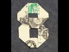 a dollar bill cut out into the shape of a face