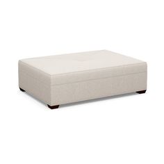 a white ottoman sitting on top of a floor