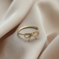 Ⓜ 14K Gold Bow Infinity Ring The bow ring in its minimal desing with the infinity symbol symbolizing innocence is one of the most beautiful gift options you can buy for yourself or your loved ones ⓂMaterials & Specifications : 14K Gold Bow Ring Ring Width : 7,21 mm (0.28 in) Ring Length : 13,61 mm (0.53 in) 3 Colours are in options. Check out our return policy for personalized products. Personalized order group All rings made to be custom made. Ring Aesthetic Minimalist, Cute Ring Designs, Bow Gold Ring, Gold Bow Jewelry, Bow Ring Gold, Ins And Outs List, Jewelry Gold Aesthetic, Gold Rings Dainty, Hold Jewelry Aesthetic