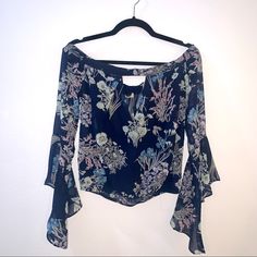 Sexy Boutique Top. Floral Print With Bell Sleeves. Off The Shoulder Style With Deep V In The Front For Perfect Cleavage. Nwt And So Cute! Fitted Floral Print Blouse For Night Out, Off-shoulder Floral Print Party Blouse, Floral Spring Tops For Night Out, Blue Off-shoulder Top With Floral Print, Blue Off-shoulder Floral Print Tops, Floral Print Summer Tops For Night Out, Chic Long Sleeve Floral Print Crop Top, Chic Floral Print Tops For Night Out, Summer Floral Print Top For Date Night