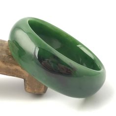 Siberian Jade Bangle. Measures approximately 50mm x 18mm. Handmade Bangle Bracelets For Formal Occasions, Elegant Round Band Jade Jewelry, Green Bangle Bracelet For Formal Occasions, Handmade Oval Bangle For Formal Occasions, Handmade Oval Bangle For Formal Events, Green Bangle Bracelets For Formal Occasions, Luxury Green Bangle Bracelets, Classic Jade Bracelets For Formal Occasions, Elegant Carved Cuff Bracelet