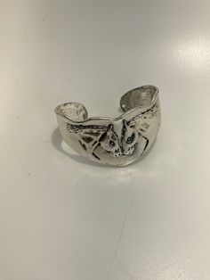 This bright silver cuff bracelet shows your love for horses - and horses for each other! The alloy metal is embossed with two horses nuzzling - what could be cuter?  It is a sturdy, heavier weight metal that is hypoallergenic and tarnish resistant but is a very good sterling look a like.  It is sized for an average size wrist but it is adjustable since it is an open cuff.  At its widest point in the center, it is 30 mm - it then tapers to 18 mm where the opening is.  There are two small holes at the opening where you could add a chain or a bead if you choose to embellish it.  It stays firmly on the wrist by itself. Adjustable Silver Friendship Cuff Bracelet, Silver Horse Design Bracelet Gift, Silver Bracelet With Horse Design For Gift, Adjustable Horse Design Bracelet, Silver Stamped Cuff Bracelet For Friendship, Silver Horse Design Bracelet Jewelry, Silver Horse Design Jewelry Bracelet, Horses Nuzzling, Two Horses