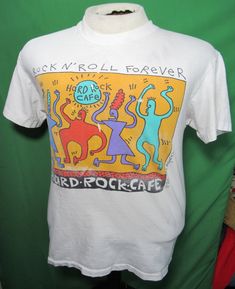 a white t - shirt with an image of cats on the front and words rock'n'roll forever