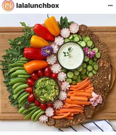 a platter filled with vegetables and dip