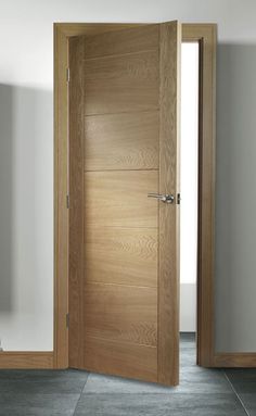 an open wooden door in a white room