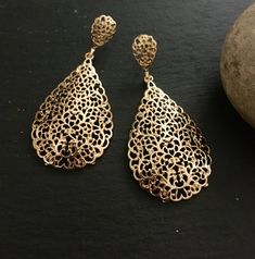 "These are lovely dangling chandelier style earrings in gold .an vintage style gold  teardrop dangle earrings  These are an Indian earrings that could be worn by both traditional and an western attire. This Unique jewellery is designed and crafted at Abi CreatioNzs Abi CreatioNzs is the place for anyone who Is in lookout for a latest trend with an ethnic touch.  We at Abi CreatioNzs offers a great range of Indian Ethnic jewellery's. We are strongly committed to  providing our customers  some uniquely handcrafted products with utmost satisfaction.  Note: The product shipped will be same as shown in the picture however, actual colours may vary slightly from those shown due to lighting in the photography Pls note The shades of gold / silver  may vary slightly. We do not accept any returns or Yellow Gold Teardrop Chandelier Earrings, Vintage Gold Chandelier Earrings For Festive Occasions, Filigree Teardrop Chandelier Earrings, Teardrop Filigree Chandelier Earrings, Festive Gold Vintage Chandelier Earrings, Festive Vintage Gold Chandelier Earrings, Elegant Bronze Pierced Chandelier Earrings, Elegant Bronze Chandelier Earrings, Gold Teardrop Chandelier Earrings For Festive Occasions