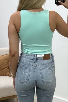 Flirt with fate in this sleek, sleeveless mint bodysuit. With a crew-neck and knit fabric, this bodysuit is perfect for layering or on its own for a night of fun. The ultimate combination of comfort and style, this bodysuit is a must-have for any fashion-forward individual looking to make a statement. 85% Polyester, 15% Spandex Riley is a size 1, wearing a small. Green Elastane Bodysuit For Summer, Chic Stretch Bodysuit For Layering, Green Elastane Bodysuit For Spring, Trendy Summer Crew Neck Bodysuit, Green Scoop Neck Bodysuit For Spring, Green Sleeveless Bodysuit For Spring, Sleeveless Green Bodysuit For Spring, Trendy Tank Bodysuit For Summer, High Stretch Scoop Neck Bodysuit For Spring