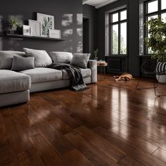 a living room filled with furniture and large windows next to a wooden floored floor