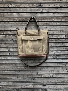 Briefcase made from heavy weight waxed filter twill in the colour ranger tan and oiled leather in the color bordeaux brown, I love the combination of these to materials. I made it big enough for laptop , and all your other necessaties. This bag is lined with a cotton canvas and there is a double inside pocket on one side. There is a large outside pocket where you can store your laptop charger and other stuff and a luggage handle attachment on the back side It closes with a metal zipper and the s Rugged Everyday Bag With Pockets, Khaki Duck Canvas Bag With Canvas Lining, Rugged Canvas Bags With Pockets, Everyday Utility Khaki Bags, Travel Satchel With Waxed Canvas Finish, Outdoor Utility Bag In Waxed Canvas, Waxed Canvas Satchel With Pockets For Outdoor, Utility Waxed Canvas Bags For Outdoor, Outdoor Waxed Canvas Satchel With Pockets