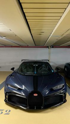 two black sports cars parked in a parking garage