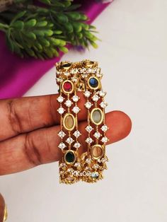 Navratan Diamond Bangles studded with multicolor semi precious stones with CZ's in gold finish. A perfect piece of art always a keeper in your jewelry trinket that goes with Ethnic Attire /  Indian outfits.  👉🏻Size Available: suitable for bangle size 2.4 / 2.6 / 2.8  👉🏻Premium Quality CZ & semi precious stones that's all it goes in here.  ✅Check other styles available in our store https://www.etsy.com/shop/KKsCulture Send us an email if you need help!  SHIPPING & TURNAROUND  👉🏻Please check listings for shipping and turnaround times.  👉🏻We follow item dispatch in 1-2 business days for most of our shipments.  👉🏻All pre orders will take approximately 3 weeks. 👉🏻Free domestic delivery across US on orders over $35.  For any other query or assistance with shipping, custom / bulk orde Navratan Bangles, Jewelry Indian Wedding, Diamond Bangles, Temple Jewelry, Art Deco Bracelet, Jewelry Trinket, Black Beaded Jewelry, Indian Wedding Jewelry, Jewelry Indian