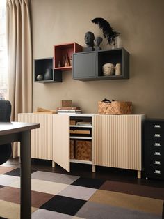 a room with a desk and shelves on the wall