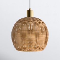 a wicker light fixture hanging from a ceiling