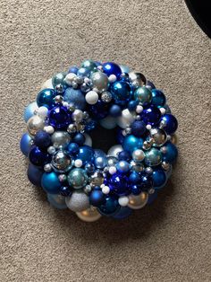 a blue and white christmas ornament sitting on the floor